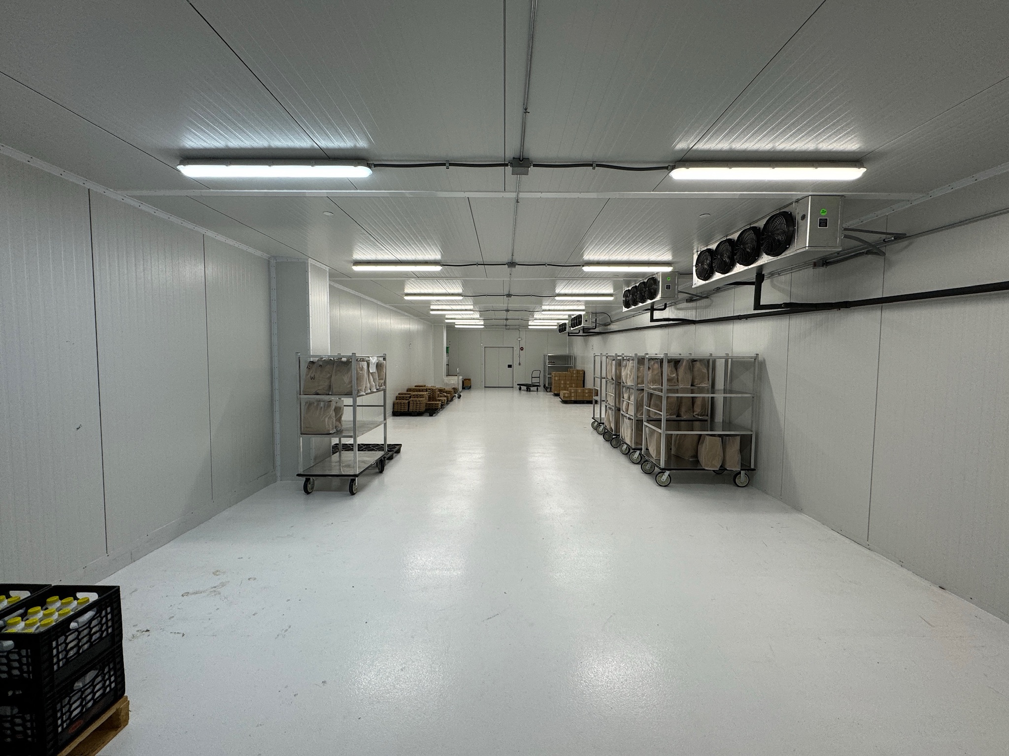 A finished RSNE cold room with product carts and evaporators along the wall